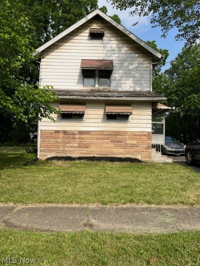 View of property exterior with a lawn | Image 1