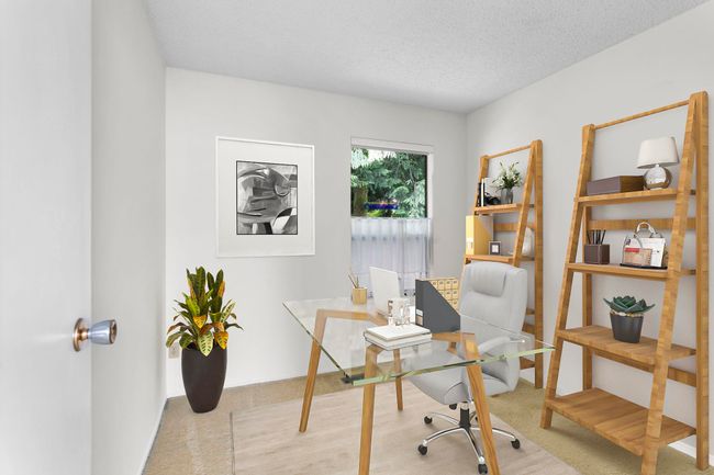 Carpeted office featuring a textured ceiling | Image 27