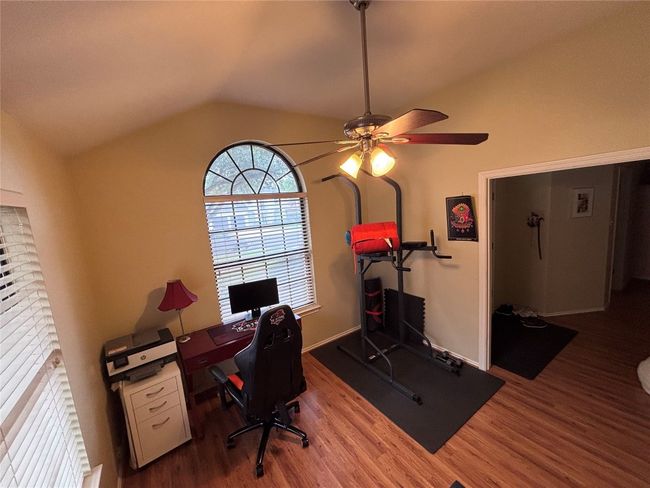 Office area featuring vaulted ceiling, wood finished floors, and a ceiling fan | Image 18