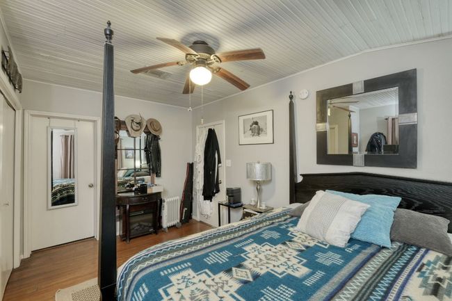 Bedroom featuring wood floors, ornamental molding, ceiling fan, and wood ceiling | Image 19