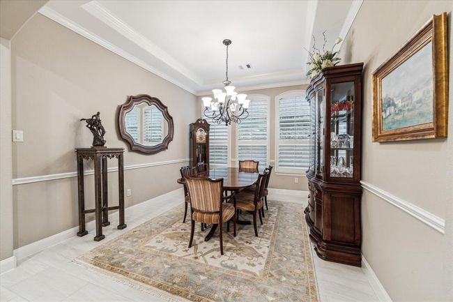Trayed ceiling and chair rail in the dining room are some of the many architectural features found in the home. | Image 5