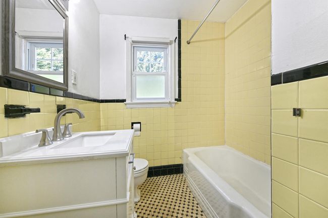 Full bath with tile walls, toilet, a healthy amount of sunlight, and vanity | Image 11