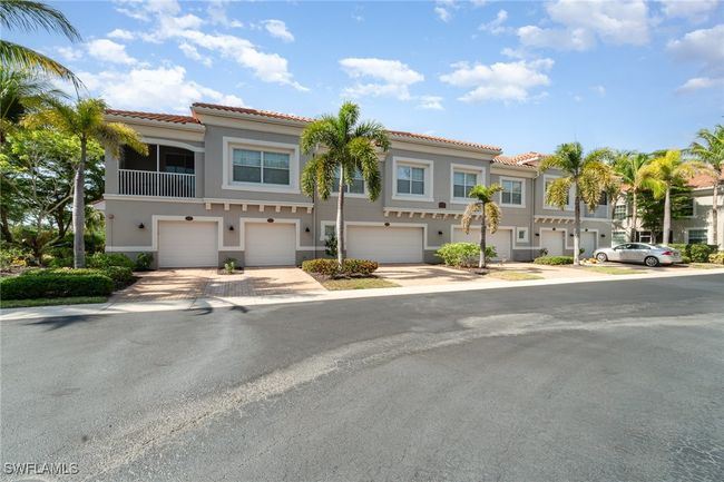 Multi unit property with a tile roof, a garage, and stucco siding | Image 27