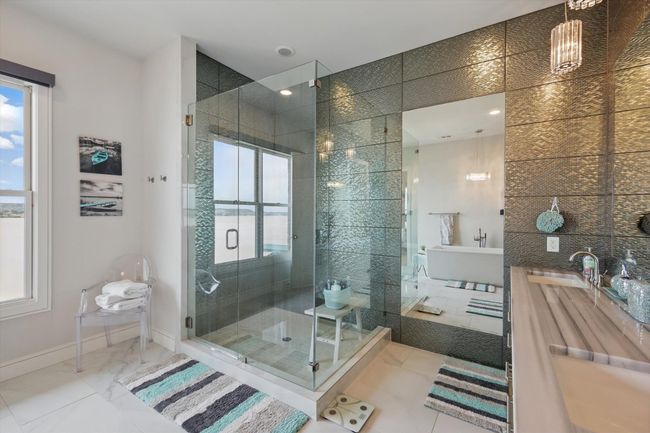 Bathroom featuring baseboards, a freestanding bath, a wealth of natural light, and a stall shower | Image 34
