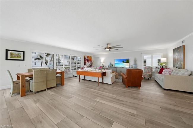 Living room with ceiling fan, crown molding, and light wood-type flooring | Image 16