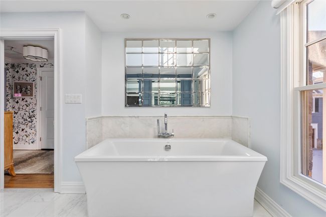 Full bathroom with marble finish floor, baseboards, and a freestanding bath | Image 32