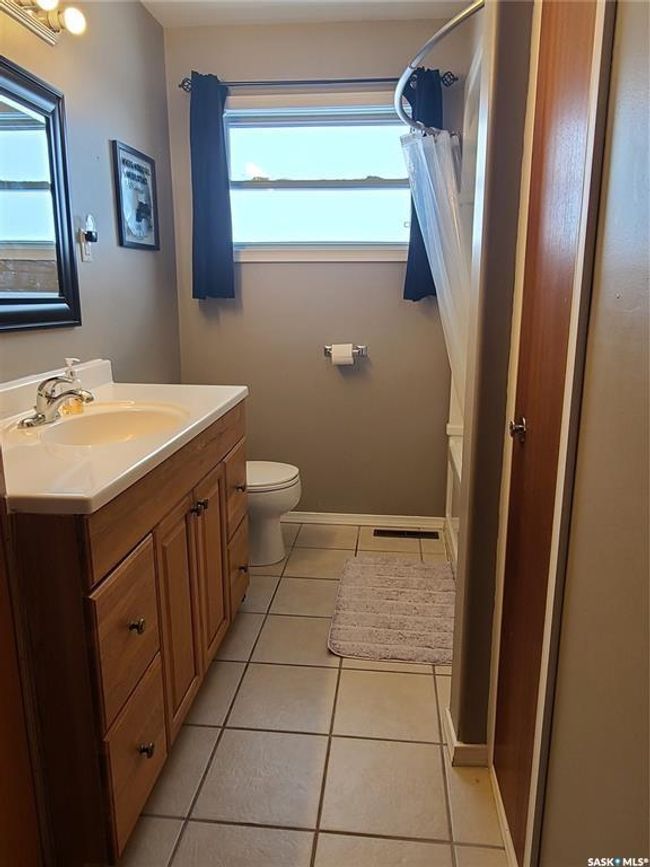 Full bathroom with tile patterned flooring, vanity, a healthy amount of sunlight, and toilet | Image 15