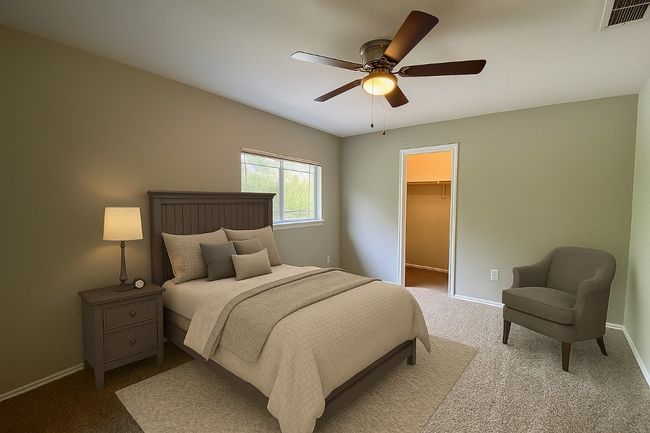 Bedroom with a spacious closet, carpet floors, a ceiling fan, and a closet | Image 25