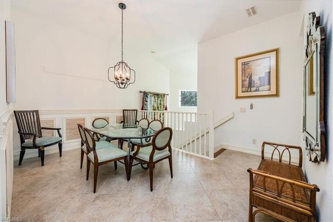Dining space with lofted ceiling and a notable chandelier | Image 10