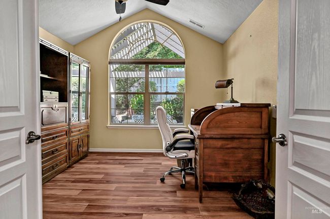 Office space featuring lofted ceiling, a ceiling fan, and wood finished floors | Image 9