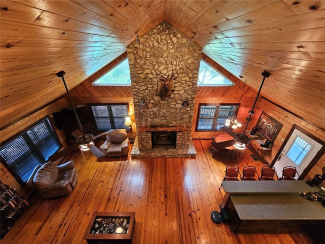 The Magnificent View of the Great Room Ceiling and Massive Rock Fireplace from the top of the Stairs! | Image 17