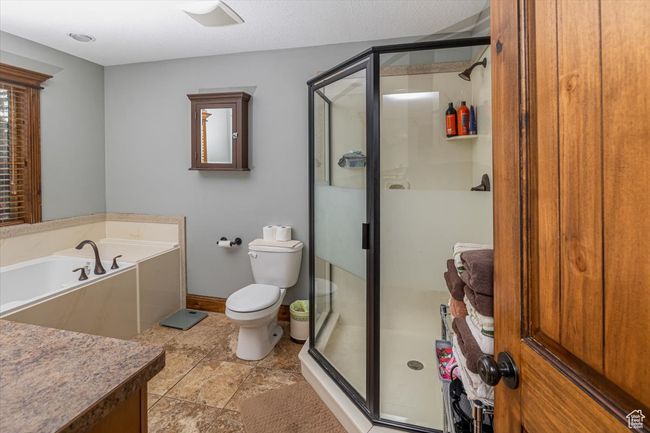 Bathroom featuring toilet and separate shower and tub | Image 21