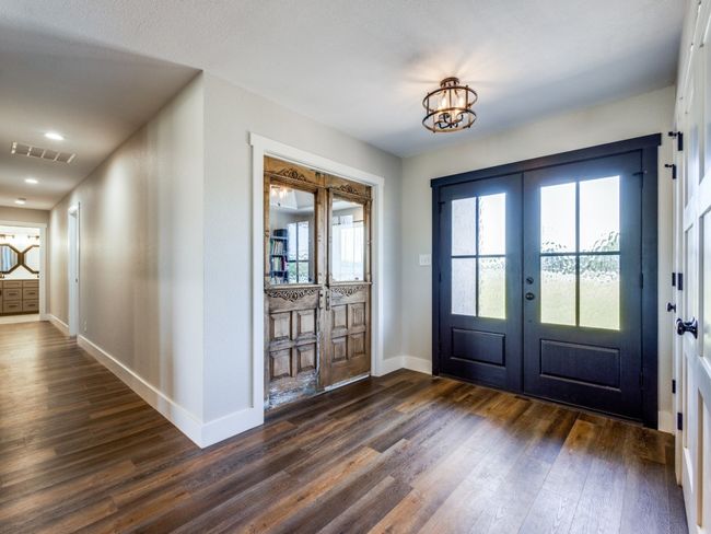 Grand entry. Antique doors to the left lead into the home office. Doorways to the right are a coat closet and a storage closet. The hallway to your left is the guest wing--two bedrooms and a beautifully updated guest bath. | Image 4