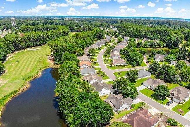 Aerial perspective of suburban area with a nearby body of water and a golf course | Image 34