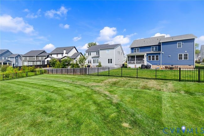 Fenced backyard featuring a residential view and a sunroom | Image 43