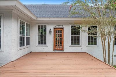 View of exterior entry with a wooden deck | Image 2