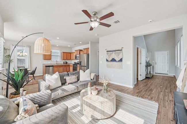 Living room featuring light wood-style flooring, ceiling fan, and recessed lighting | Image 7