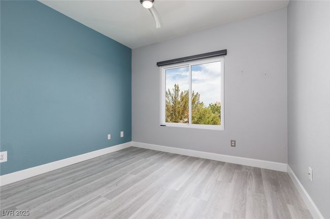 Empty room with baseboards, light wood-style floors, and ceiling fan | Image 16
