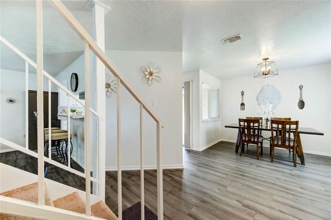 Step into a spacious, light-filled foyer featuring gorgeous luxury vinyl flooring that flows seamlessly into the dining area | Image 16
