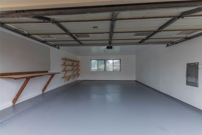 Garage with electric panel and a garage door opener | Image 38