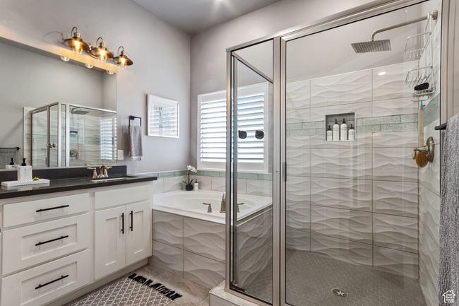 Full bathroom with tile patterned floors, a garden tub, vanity, and a stall shower | Image 14