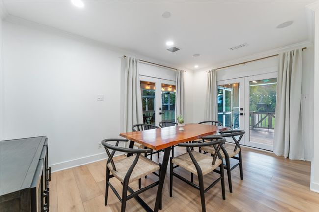 Large dining area with two sets of French doors and stunning views of the pool area and private backyard | Image 13