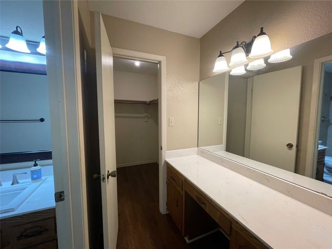 Bathroom featuring wood finished floors, vanity, and a spacious closet | Image 22