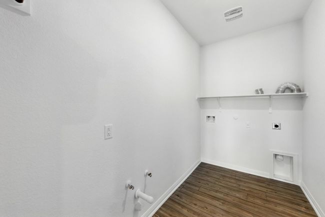 Laundry room featuring gas dryer hookup, hookup for an electric dryer, washer hookup, and dark wood-style flooring | Image 30