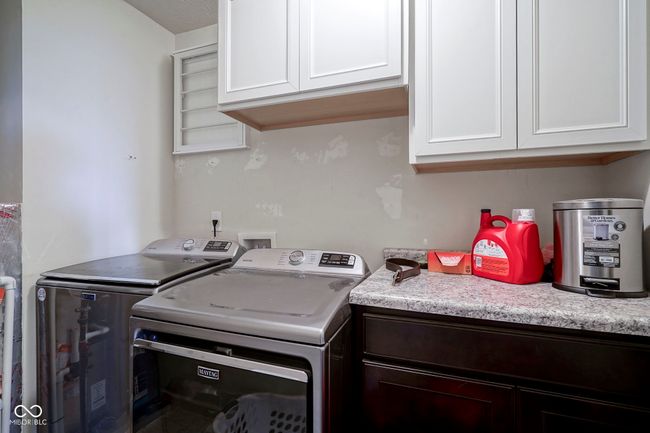 washroom with washer and clothes dryer and cabinet space | Image 34