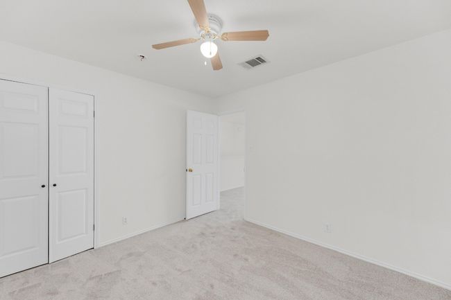 Unfurnished bedroom with a ceiling fan, a closet, carpet, baseboards, and visible vents | Image 26