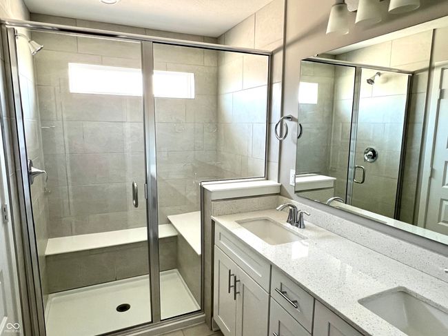Primary en-suite bathroom with large shower with seating, double vanity & separate water closet | Image 41