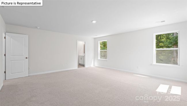 Primary bedroom with doorway through to en-suite bathroom | Image 25