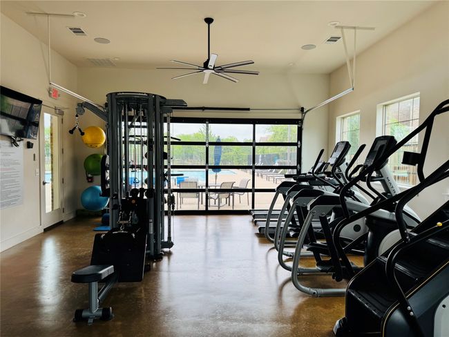 Community center offers a convenient work out facility that overlooks the pool. | Image 40