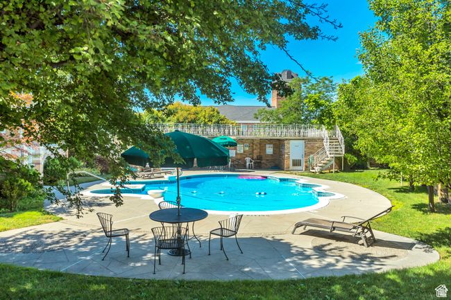 Outdoor pool with a yard, a patio area, and stairway | Image 25