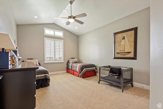 Bedroom featuring vaulted ceiling, carpet floors, baseboards, and ceiling fan | Image 21