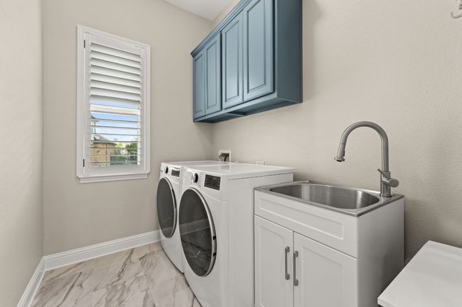 First floor laundry room with sink and newly remodeled floors. | Image 15