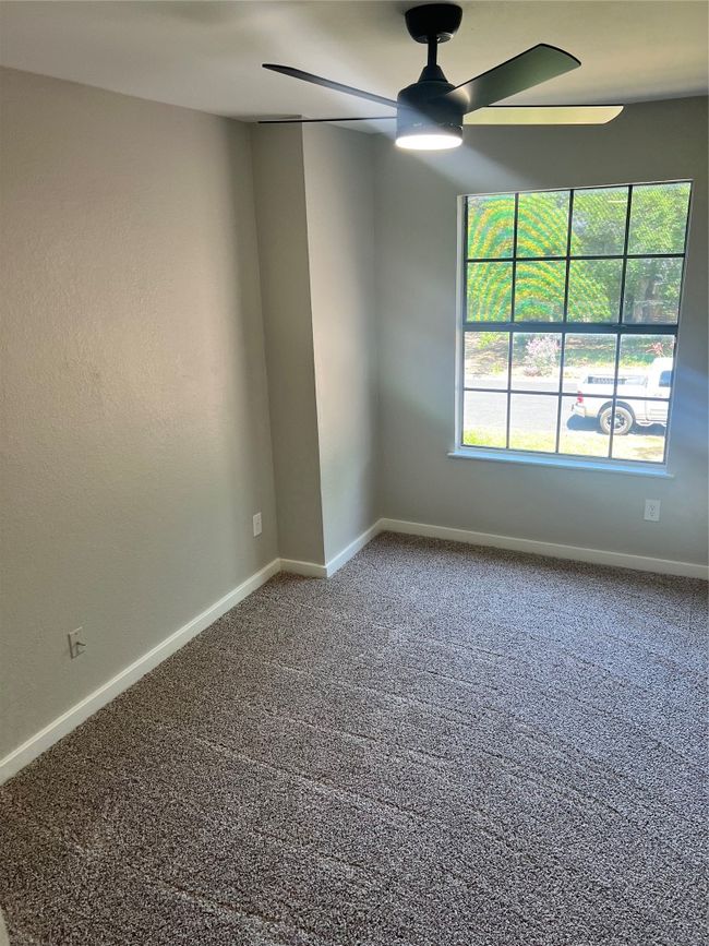 Spare room with a ceiling fan and carpet floors | Image 18