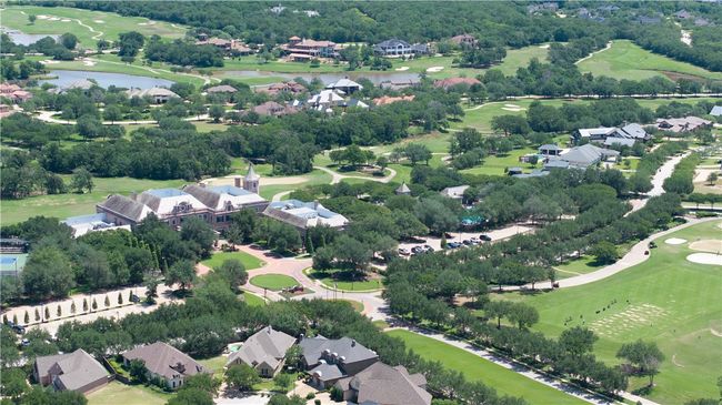 Aerial perspective of suburban area featuring a nearby body of water, a golf club, and a tree filled landscape | Image 38