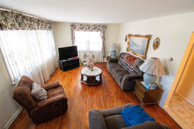 Living area featuring wood finished floors and baseboards | Image 16