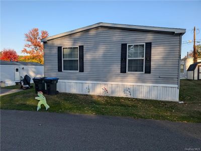 View of property exterior with a yard | Image 1