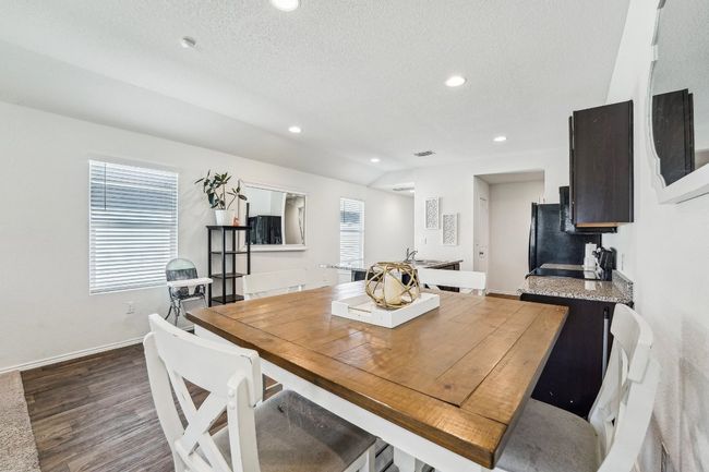 Dining space with baseboards, lofted ceiling, recessed lighting, dark wood-style flooring, and a textured ceiling | Image 6