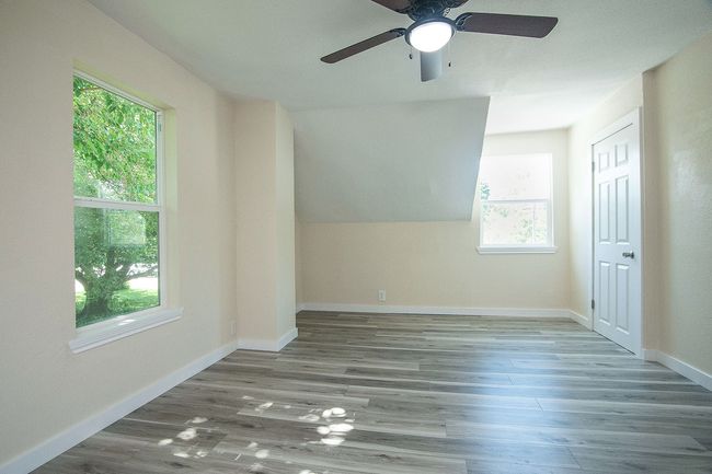 2nd floor room with a ceiling fan and wood finished floors | Image 21