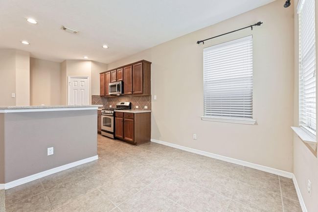 Breakfast area conveniently located next to the kitchen, family room, and access to the backyard patio | Image 19