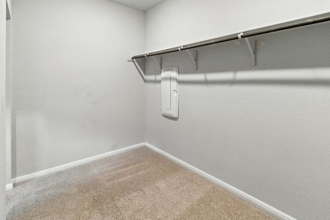 Walk in closet featuring carpet and electric panel | Image 16
