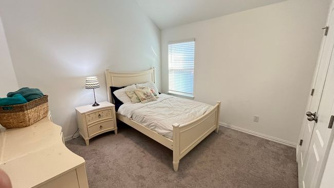 Carpeted bedroom 3 with lofted ceiling and baseboards | Image 25