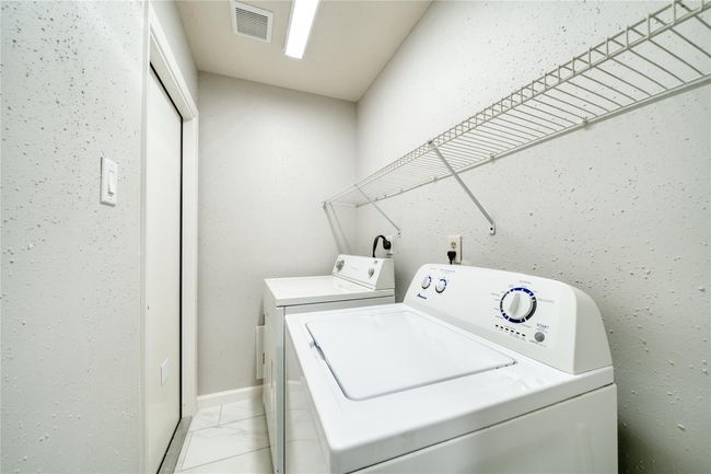 Utility room inside home and access to garage | Image 16