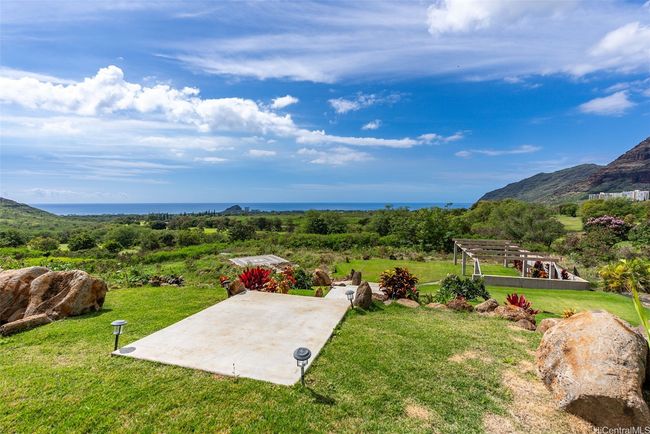 From the pool, there are steps that lead to the lower acre. The trellis on the right which can be covered or decorated for events or lounging, plenty of flat grass space for seating and sunbathing, a helipad (square in the center, requires permission to land - not permitted - a helicopter has landed here). Room for hosting events such as weddings, birthdays, parties, and a home can be built on this lower acre, possibly multiple smaller structures. | Image 19