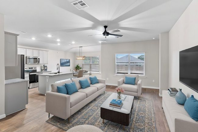 Virtually staged Living area featuring baseboards, visible vents, recessed lighting, ceiling fan, and light wood-type flooring | Image 16