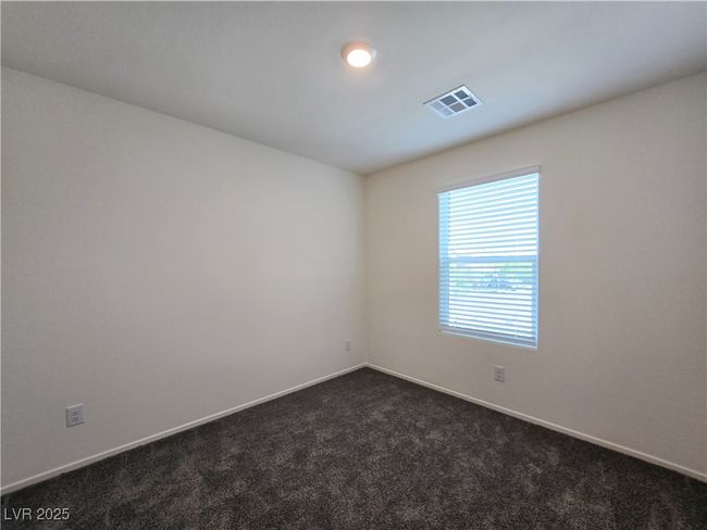 Unfurnished room featuring dark colored carpet and baseboards | Image 22
