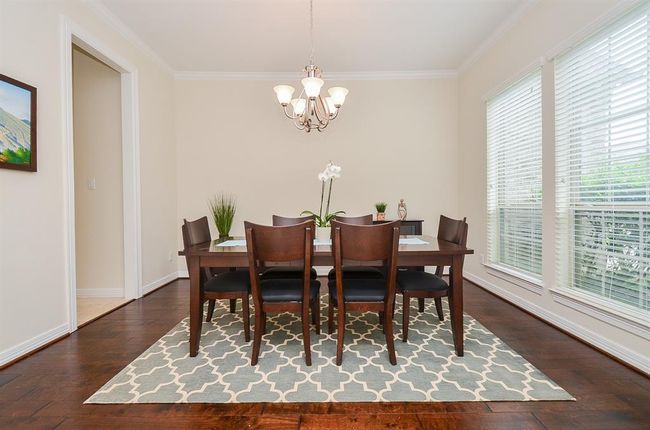 Formal dining with wood flooring and direct access to kitchen. | Image 8
